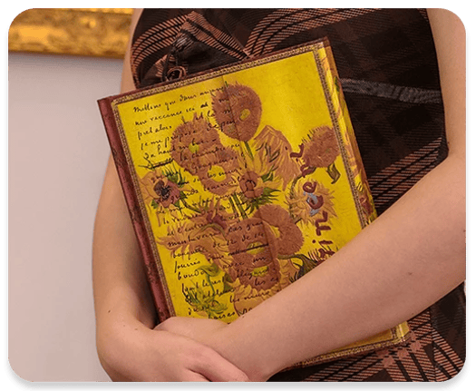 Person holding Van Gogh’s Sunflowers Journal (1989).