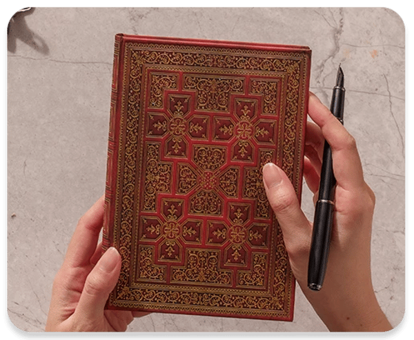 Folgear Shakespear journal held with Pen in hands.